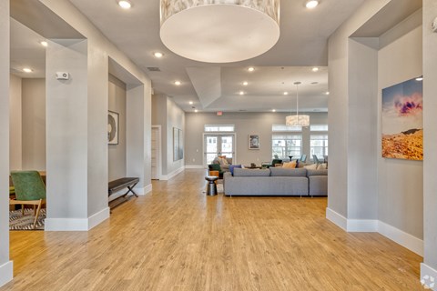 a large living room with a couch and a chandelier